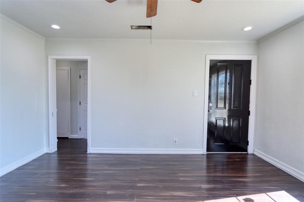 2222 Houston Street Grand Prairie, TX 75050 - Photo 4 of 24 a view of an empty room with wooden floor