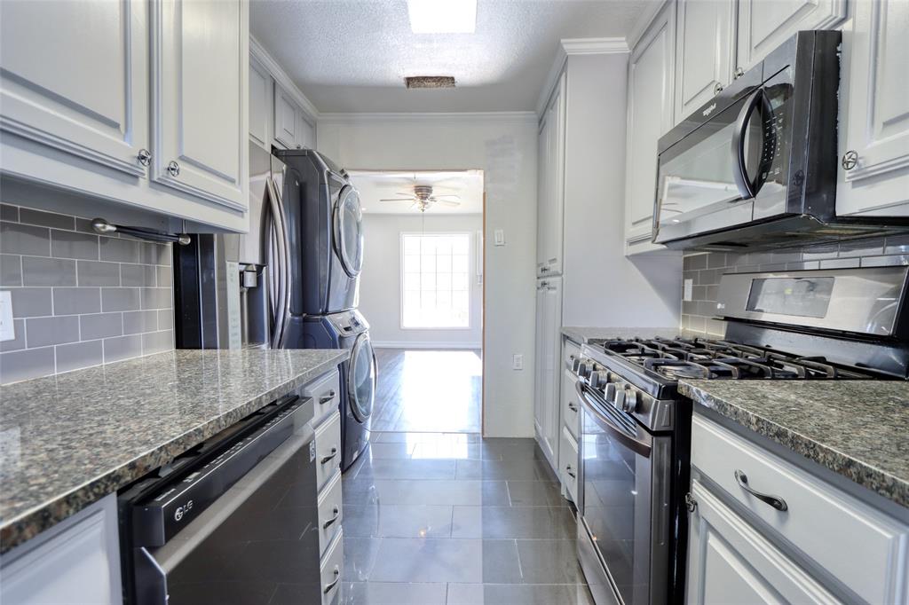 2222 Houston Street Grand Prairie, TX 75050 - Photo 6 of 24 a kitchen with stainless steel appliances granite countertop a stove and a sink