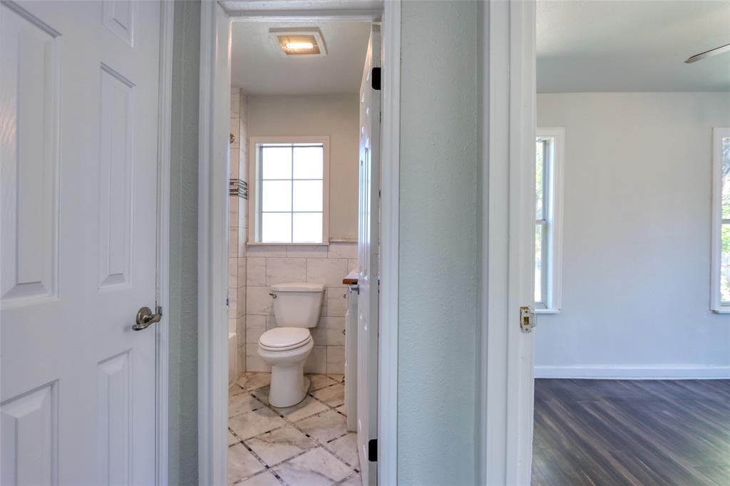 2222 Houston Street Grand Prairie, TX 75050 - Photo 9 of 24 a view of bathroom with a toilet sink