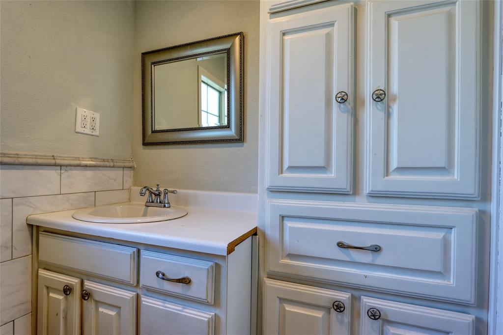 2222 Houston Street Grand Prairie, TX 75050 - Photo 10 of 24 a bathroom with a sink and a mirror