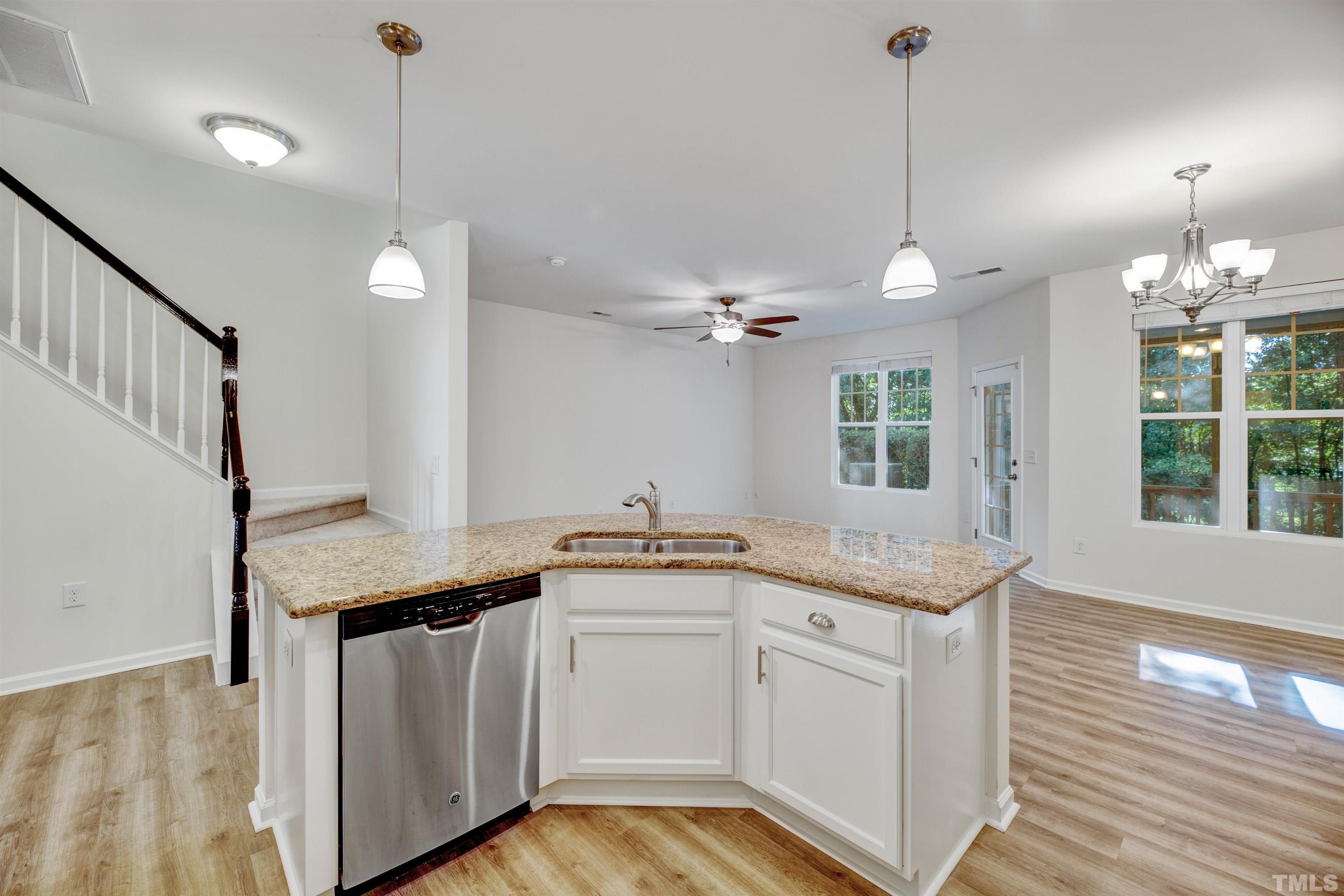 714 Treviso Lane Apex, NC 27502 - Photo 11 of 41 a kitchen with granite countertop a sink a counter space appliances and cabinets