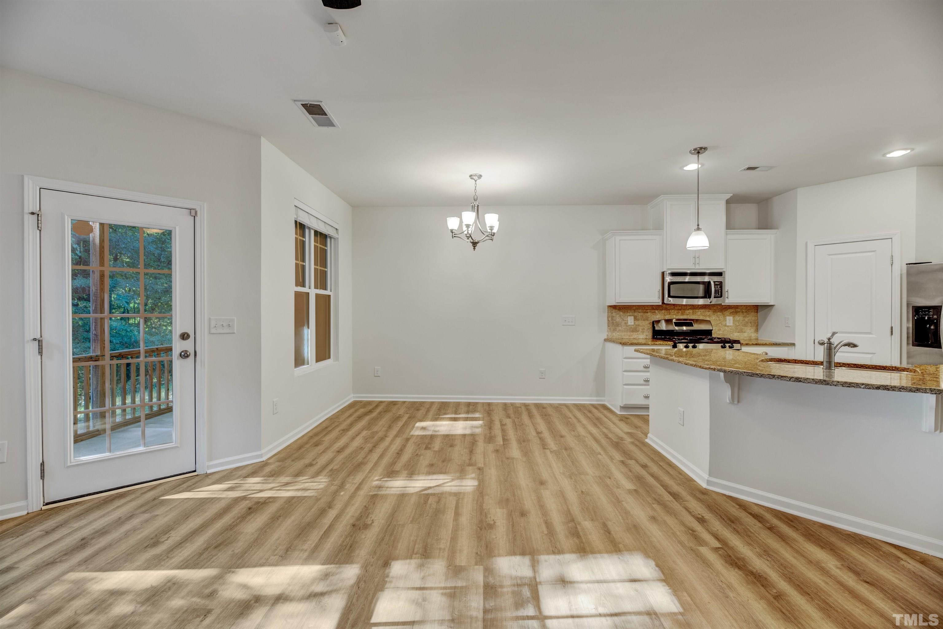 714 Treviso Lane Apex, NC 27502 - Photo 14 of 41 a view of kitchen with sink microwave and stove
