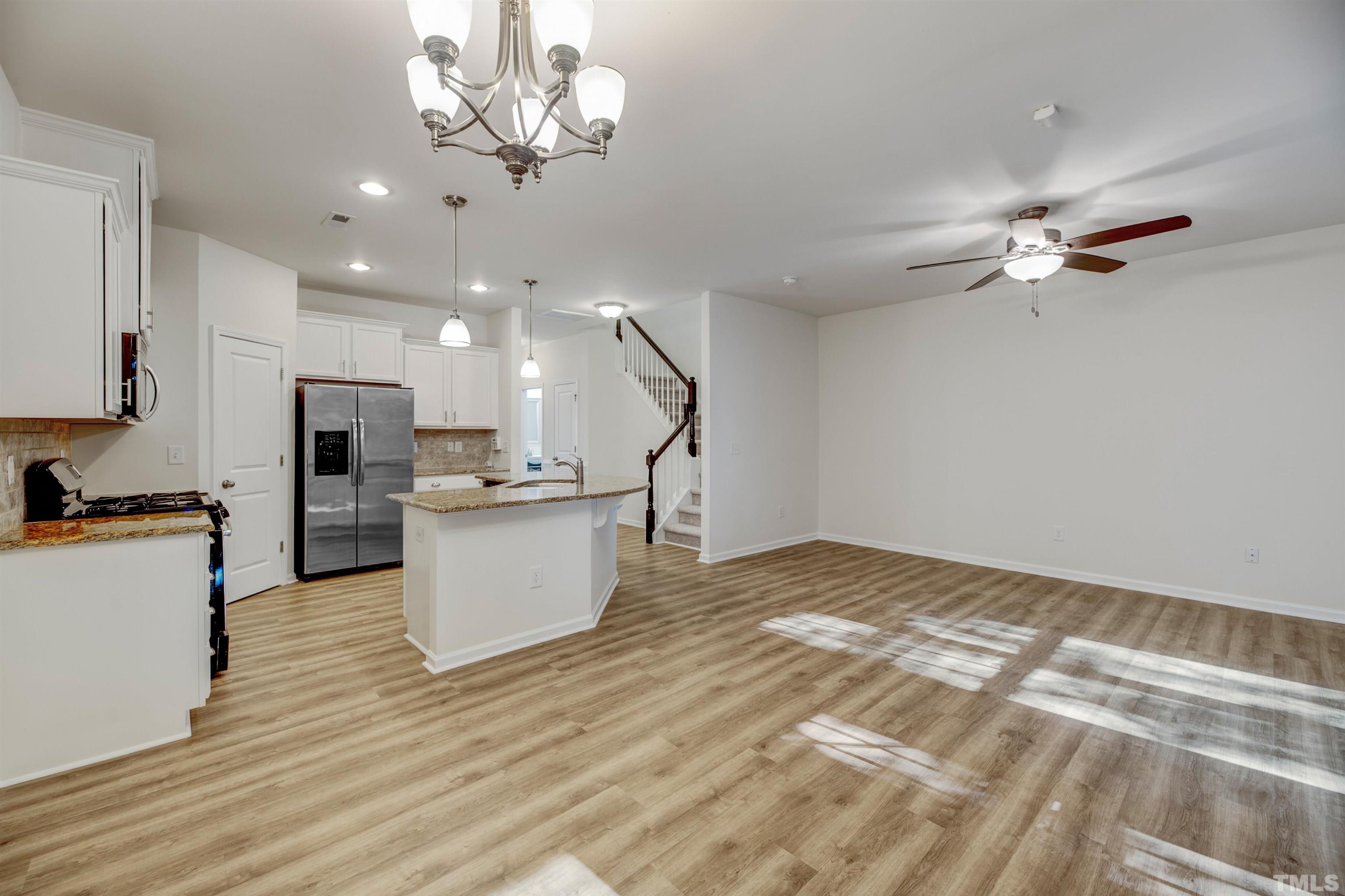 714 Treviso Lane Apex, NC 27502 - Photo 15 of 41 a view of kitchen and kitchen with stove top oven