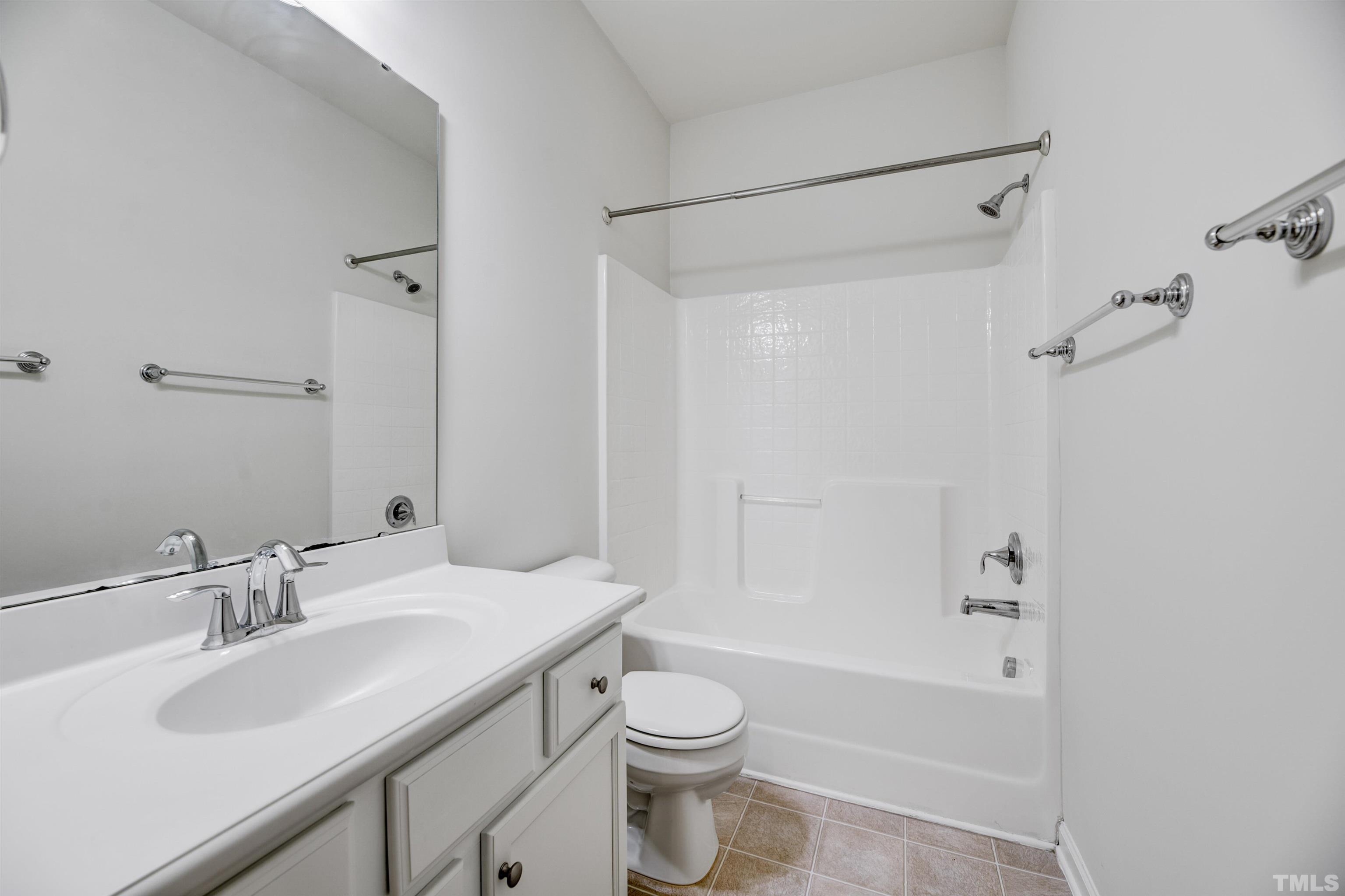 714 Treviso Lane Apex, NC 27502 - Photo 27 of 41 a bathroom with a sink toilet vanity and shower