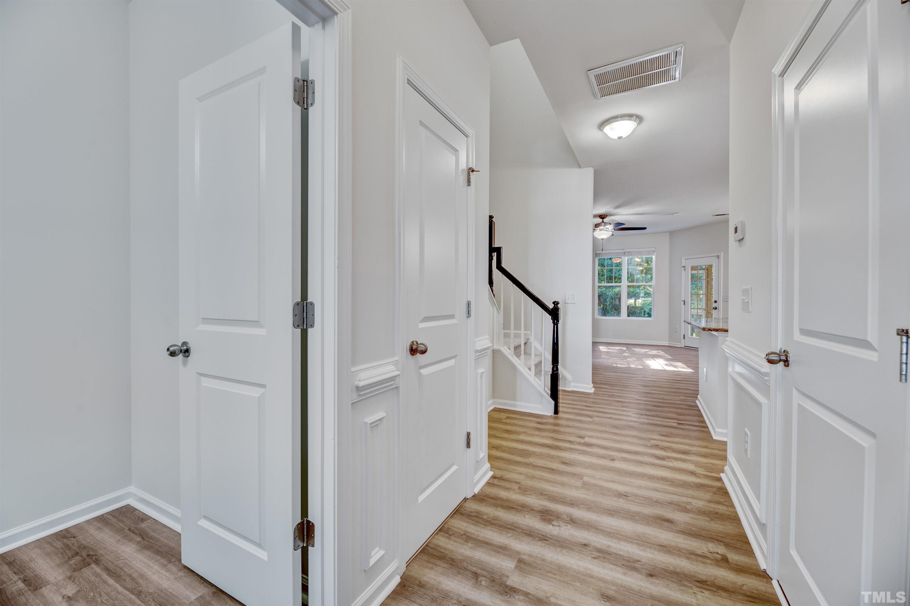 714 Treviso Lane Apex, NC 27502 - Photo 4 of 41 a view of a hallway with wooden floor and staircase