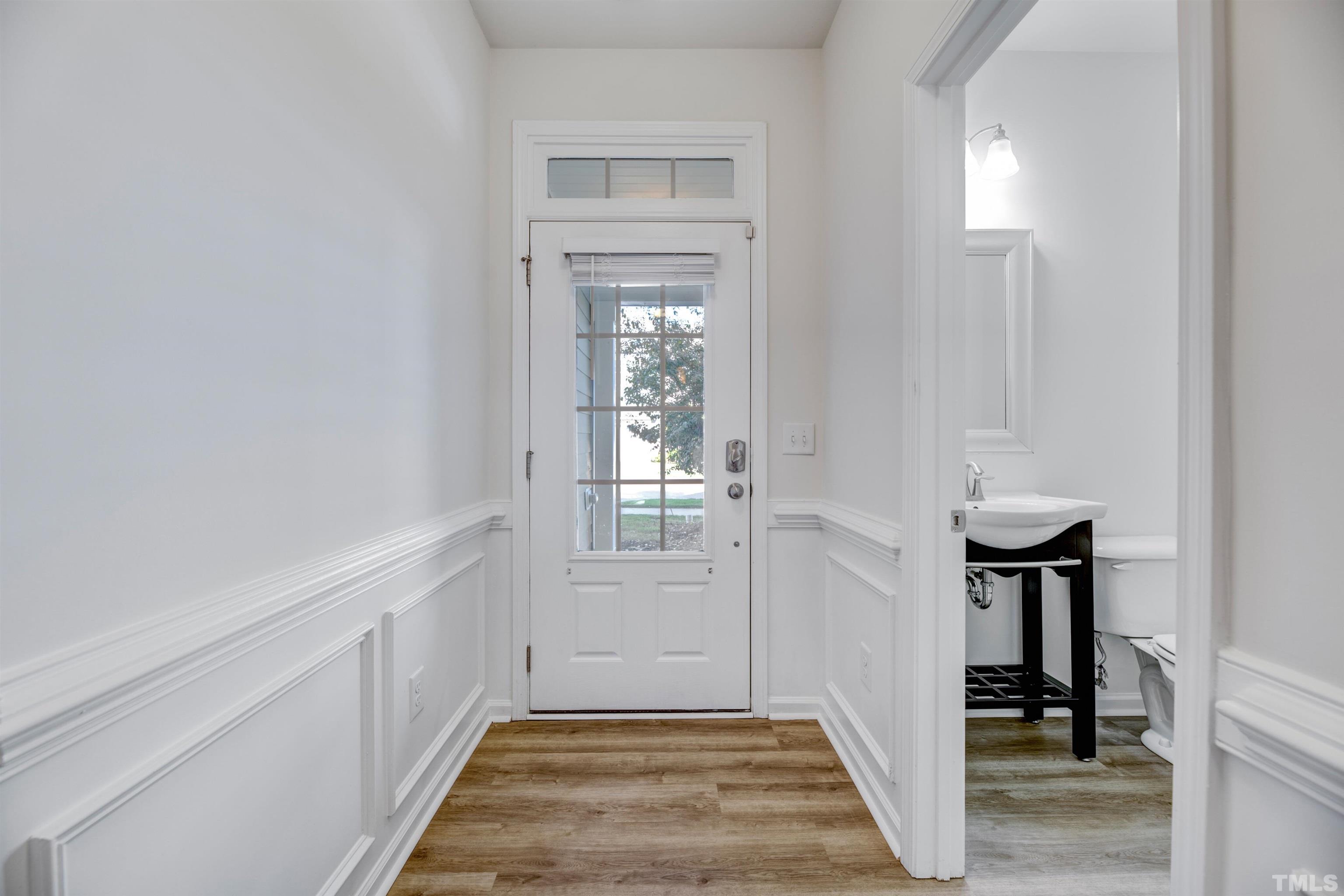 714 Treviso Lane Apex, NC 27502 - Photo 5 of 41 a view of a livingroom with wooden floor and a chair