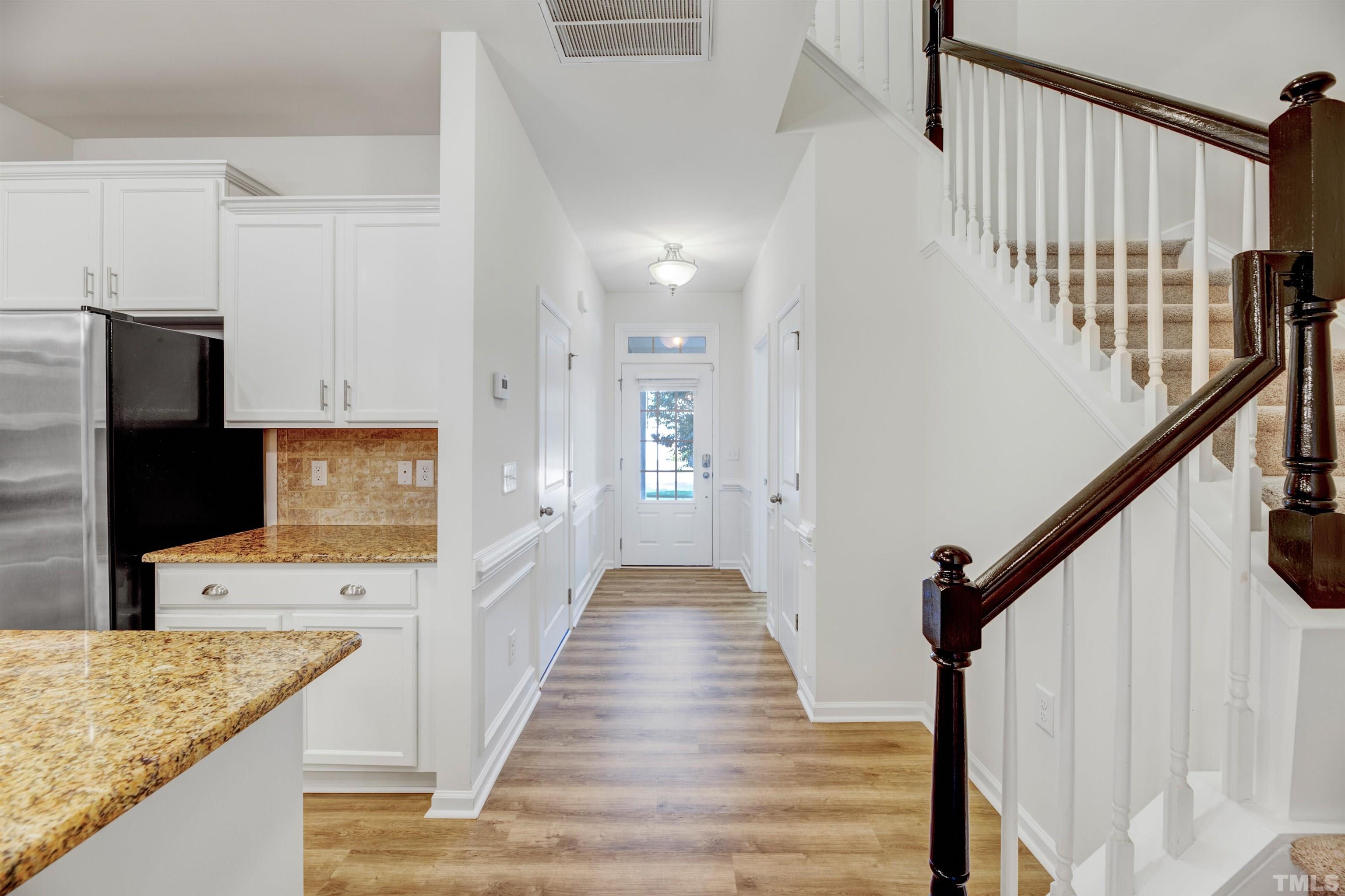 714 Treviso Lane Apex, NC 27502 - Photo 6 of 41 a view of a kitchen with wooden floor and electronic appliances