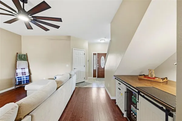 a living room with furniture and wooden floor