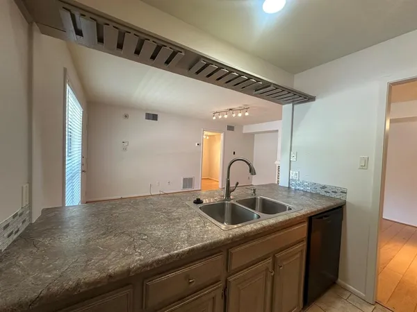 a kitchen with a sink and cabinets