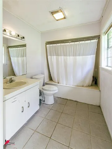 a spacious bathroom with a granite countertop sink a toilet and a mirror