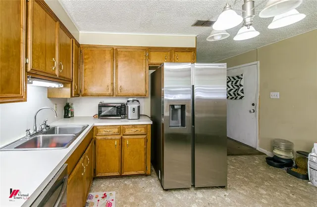 a kitchen with a refrigerator and a sink