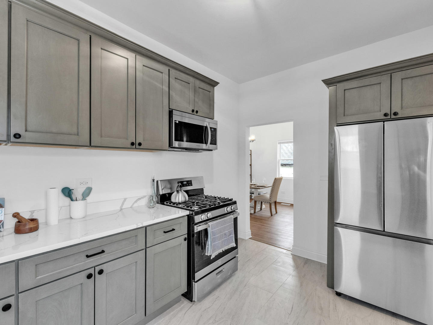 2343 Ridgeland Avenue Berwyn, IL 60402 - Photo 12 of 30 a kitchen with a refrigerator a stove a sink and white cabinets
