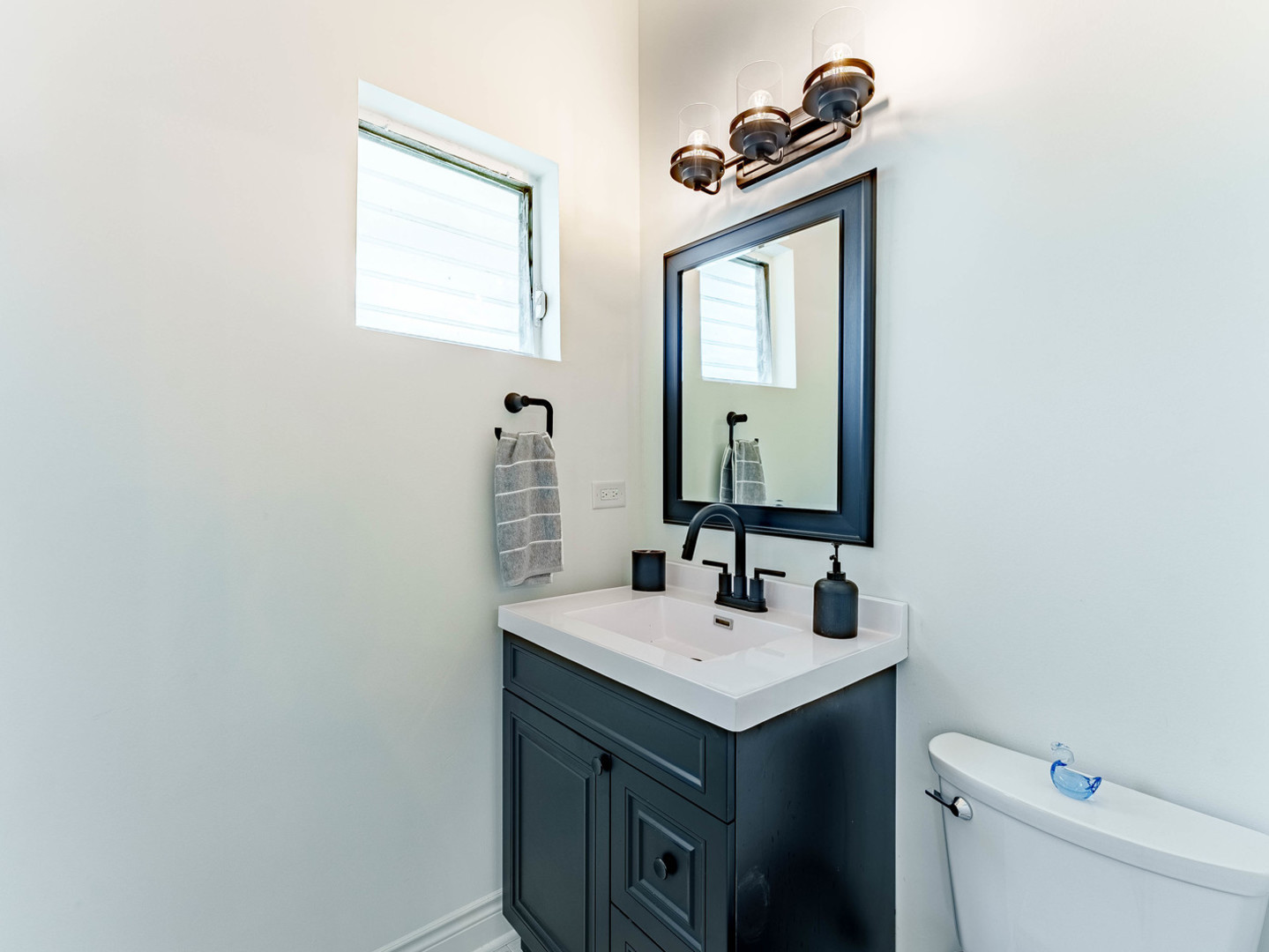 2343 Ridgeland Avenue Berwyn, IL 60402 - Photo 15 of 30 a bathroom with a sink a toilet and mirror