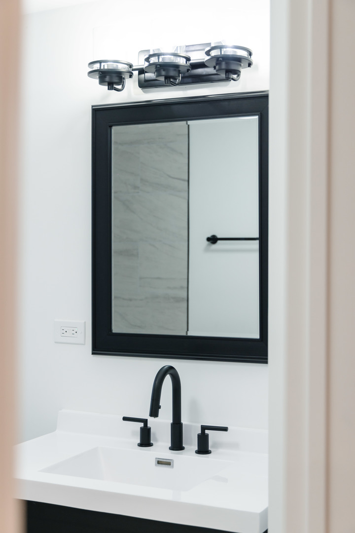 2343 Ridgeland Avenue Berwyn, IL 60402 - Photo 23 of 30 a close view of a sink and mirror in a bathroom