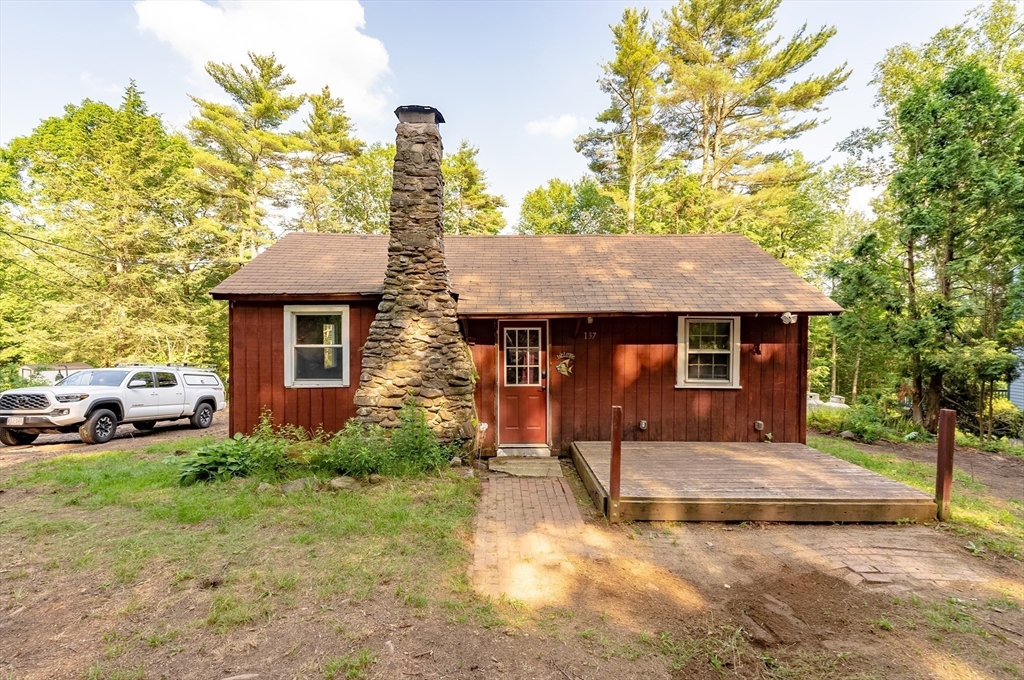 137 Rainbow Road Otis, MA 01029 - Photo 3 of 31 a front view of a house with a yard and garage