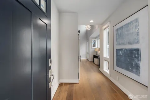 a view of hallway with wooden floor