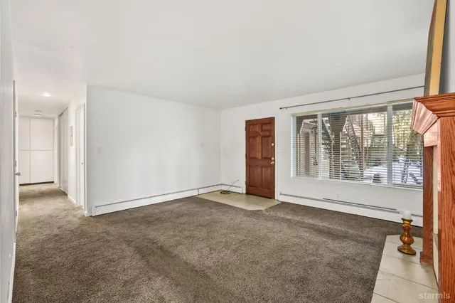 a view of an empty room with a fireplace