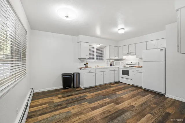 a kitchen with white cabinets and white appliances