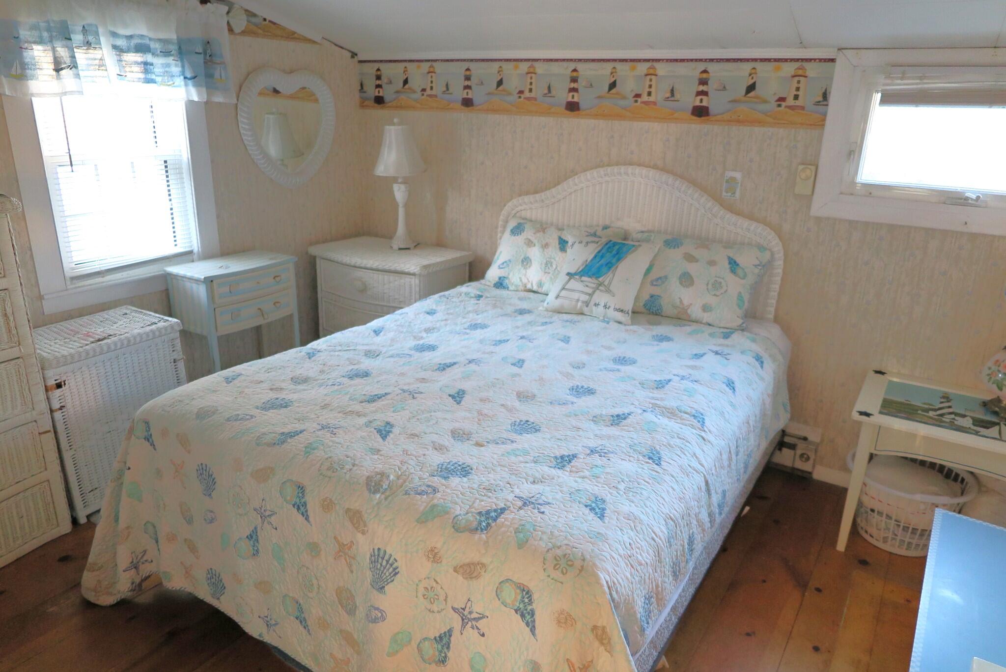50 Lower County Road Dennis Port, MA 02639 - Photo 11 of 28 a large bed sitting in a bedroom next to a window