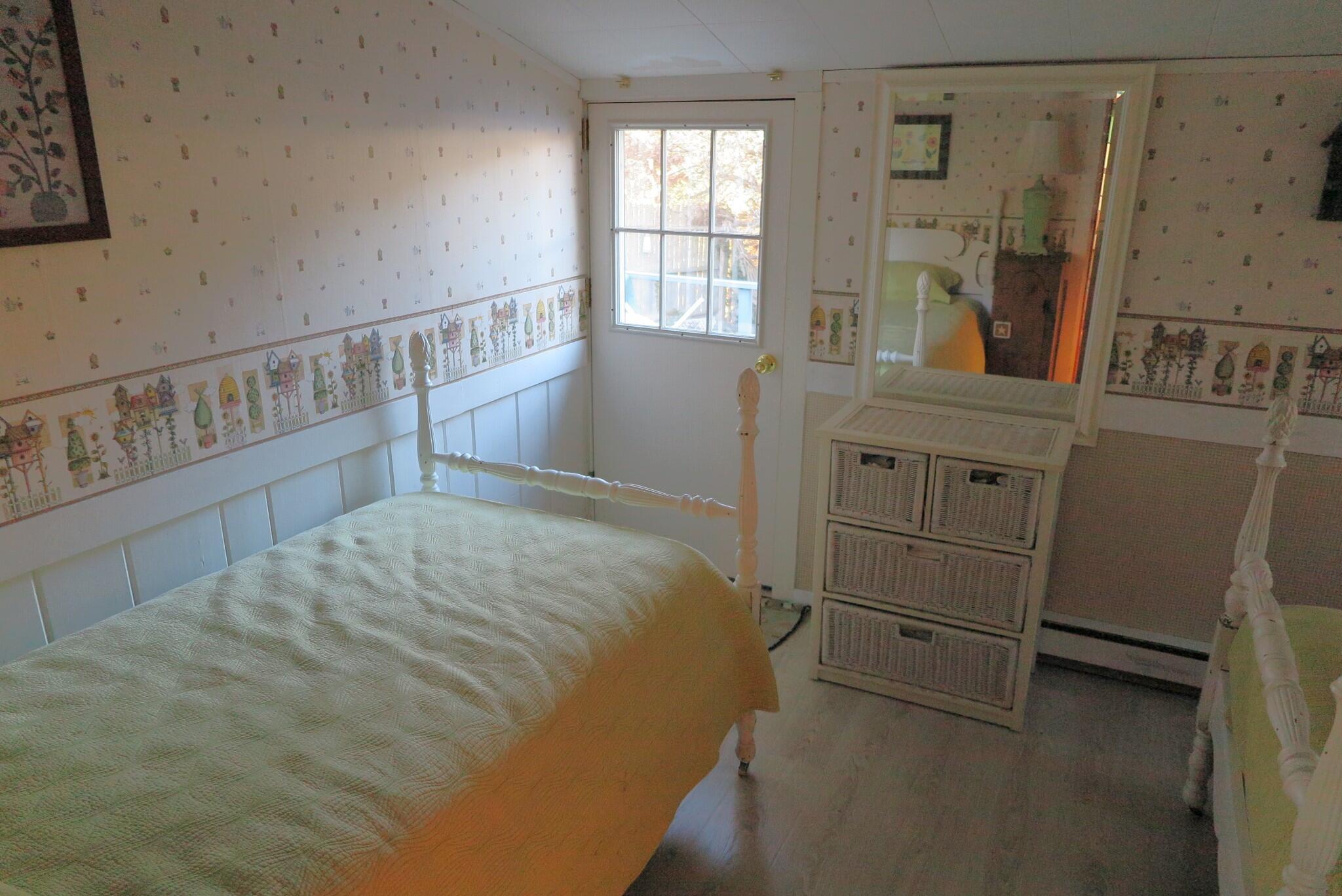 50 Lower County Road Dennis Port, MA 02639 - Photo 12 of 28 a bedroom with a bed and a window