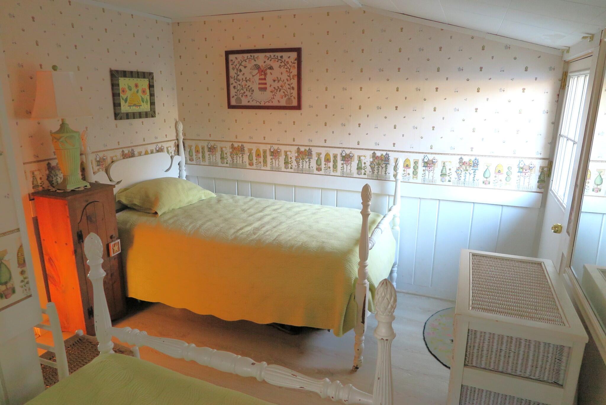 50 Lower County Road Dennis Port, MA 02639 - Photo 14 of 28 a bed sitting in a bedroom next to a window