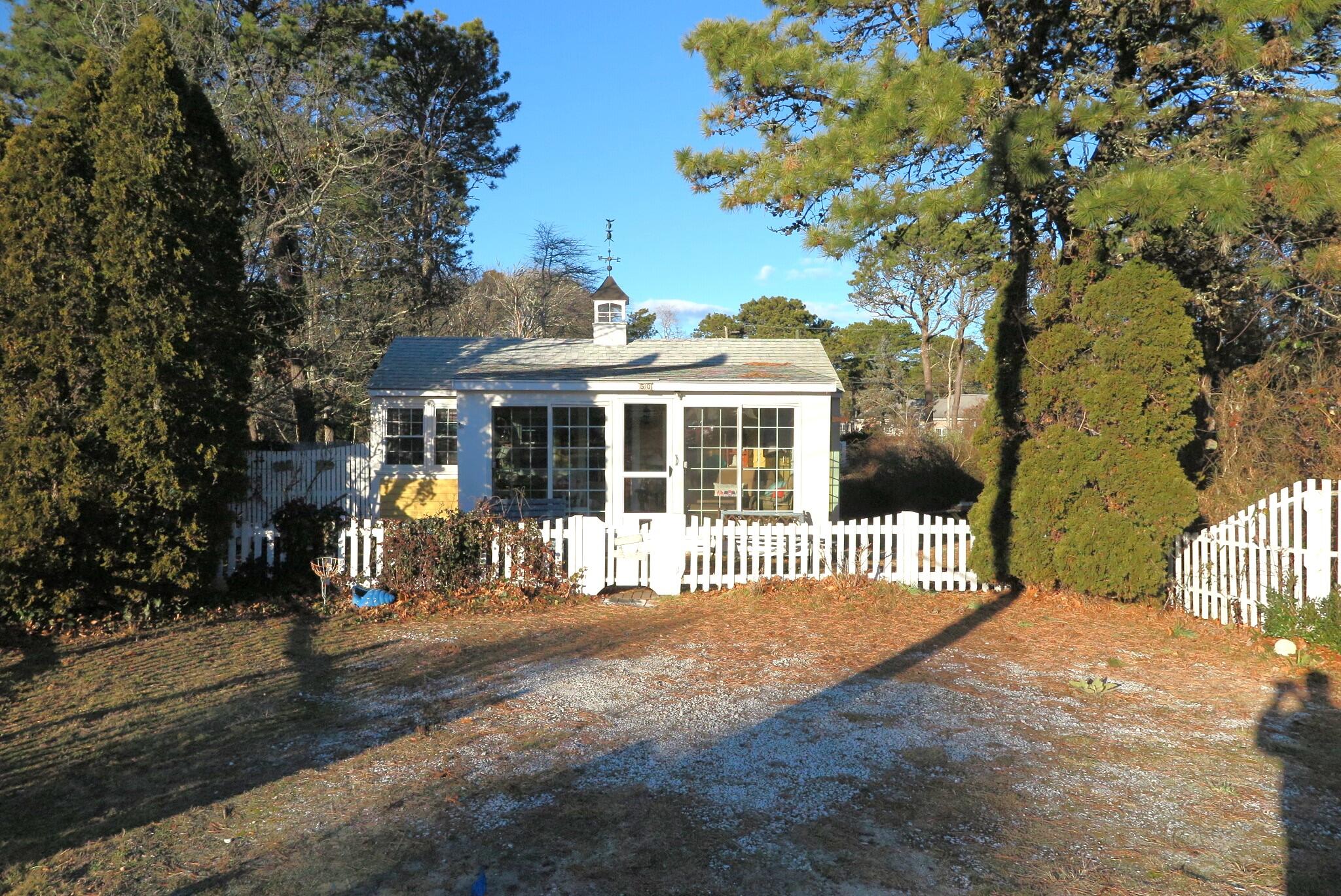 50 Lower County Road Dennis Port, MA 02639 - Photo 18 of 28 a front view of a house with a garden