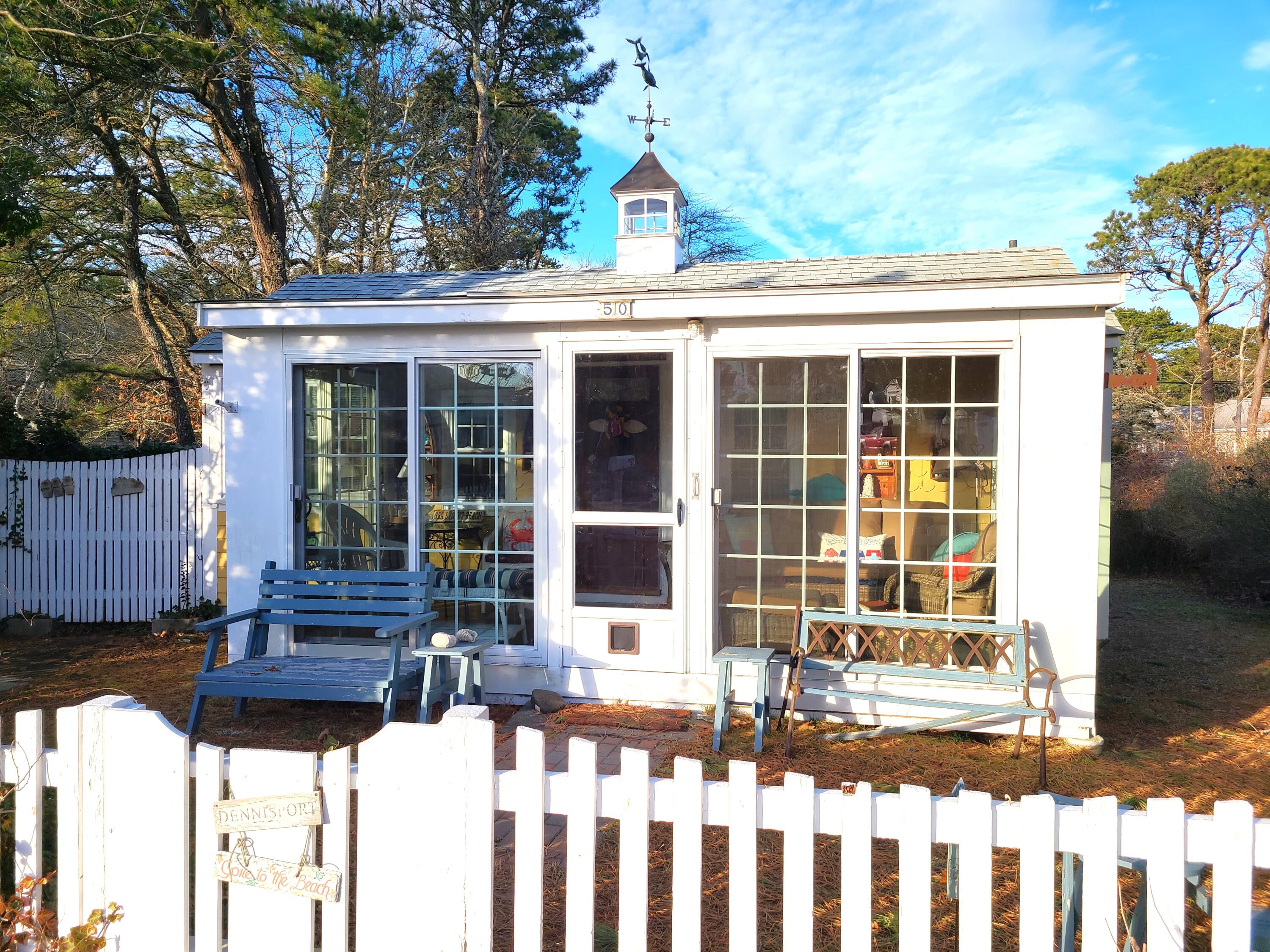 50 Lower County Road Dennis Port, MA 02639 - Photo 19 of 28 a front view of a house with a large window