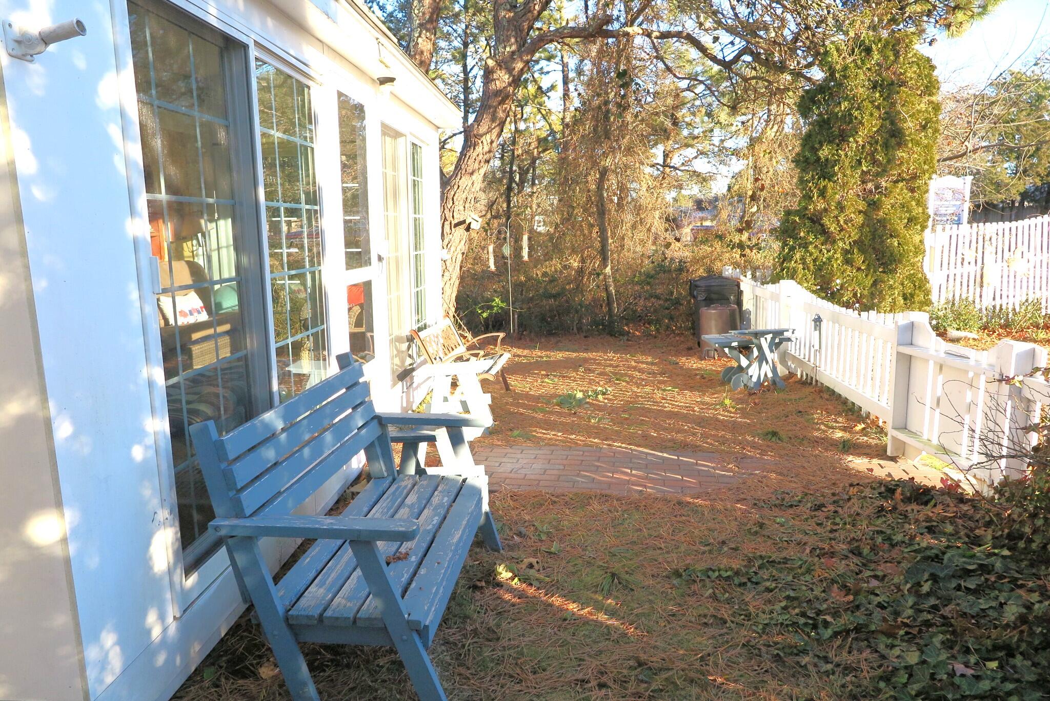 50 Lower County Road Dennis Port, MA 02639 - Photo 20 of 28 a view of a patio with table and chairs and potted plants