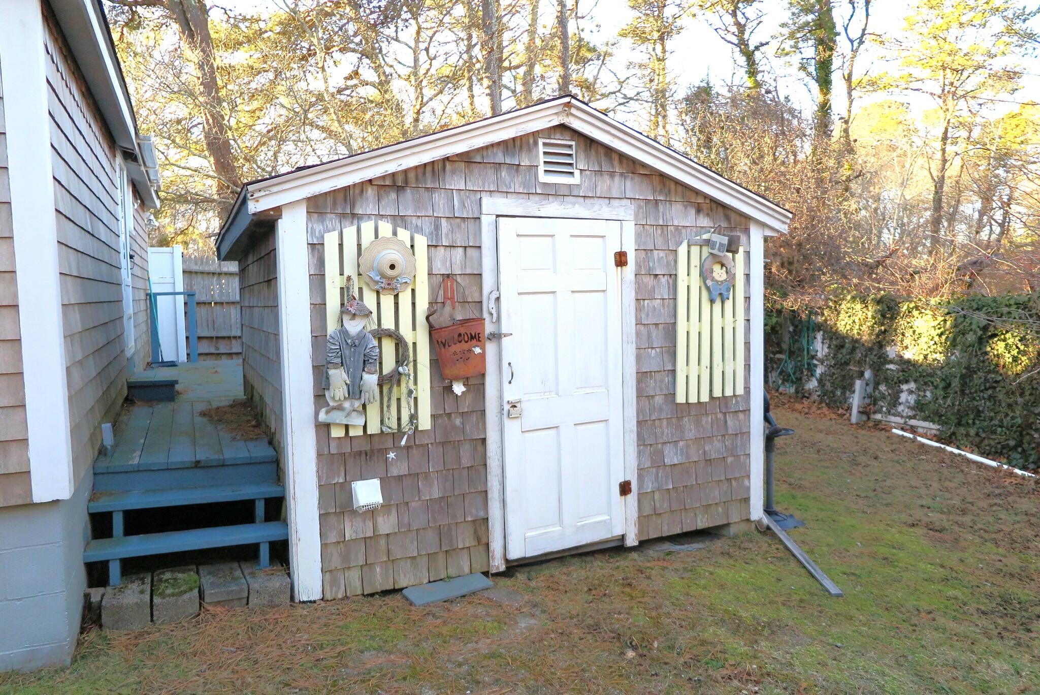 50 Lower County Road Dennis Port, MA 02639 - Photo 23 of 28 a front view of a house with a porch