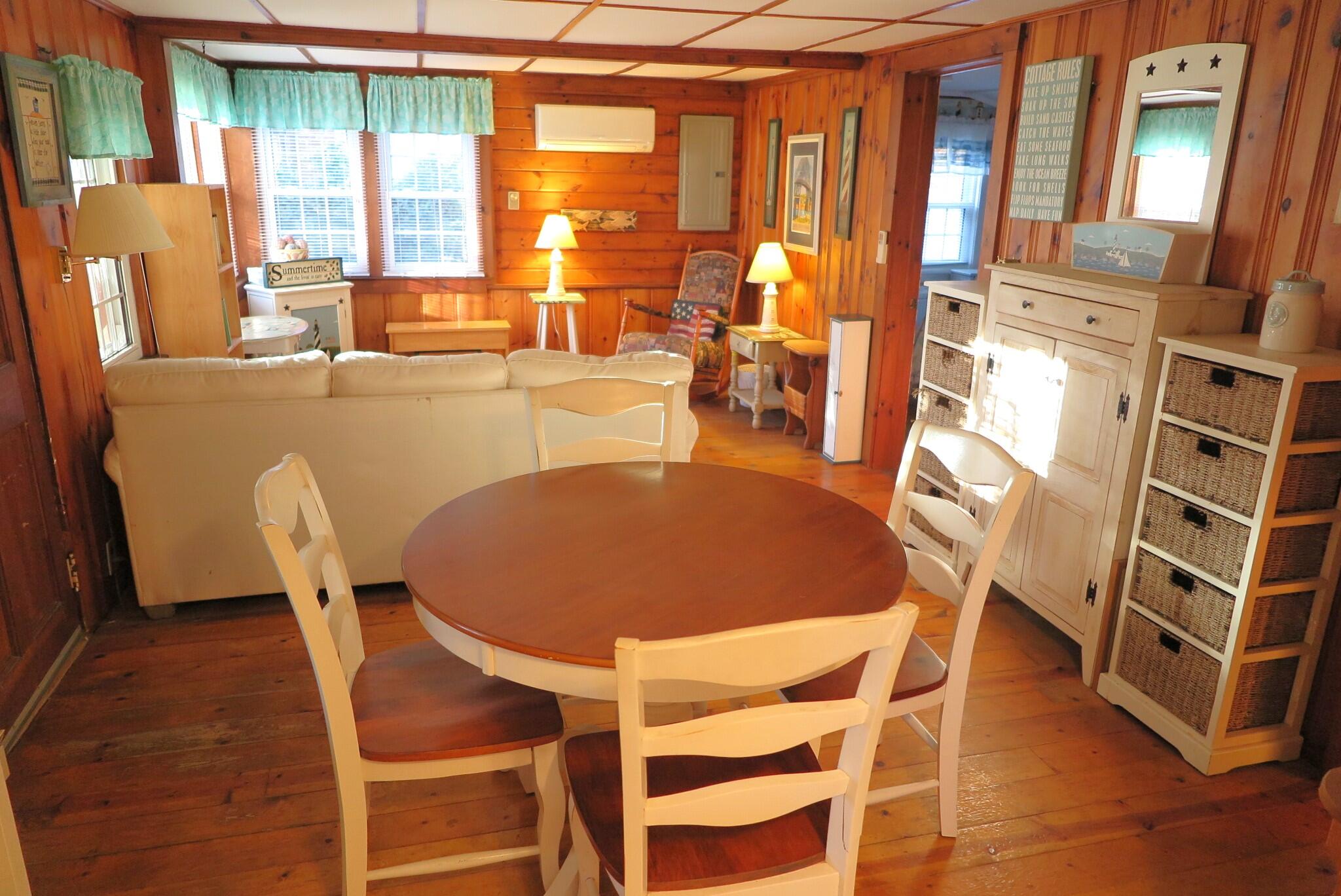 50 Lower County Road Dennis Port, MA 02639 - Photo 2 of 28 a dining room with furniture and large windows