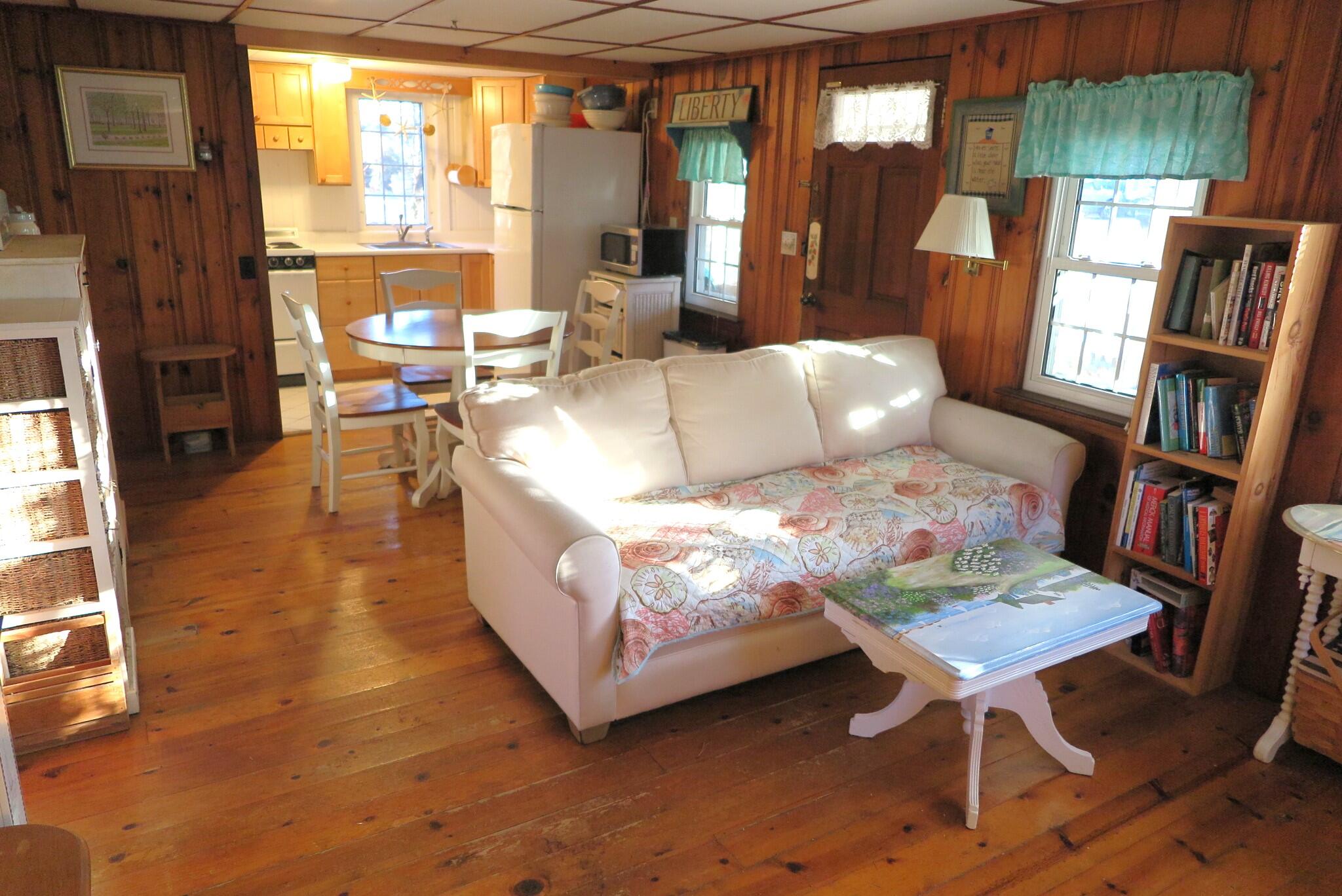 50 Lower County Road Dennis Port, MA 02639 - Photo 4 of 28 a living room with furniture and a floor to ceiling window