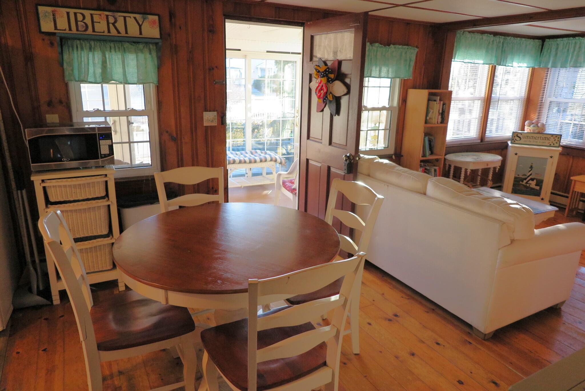 50 Lower County Road Dennis Port, MA 02639 - Photo 5 of 28 a view of a dining room with furniture and a window