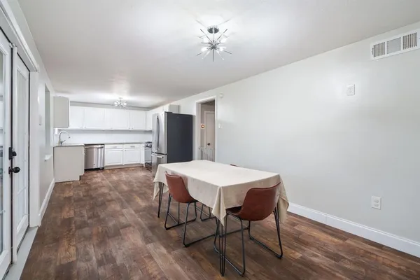 a view of a dining room with furniture and wooden floor