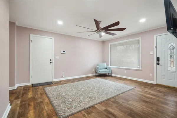 an empty room with closet and windows