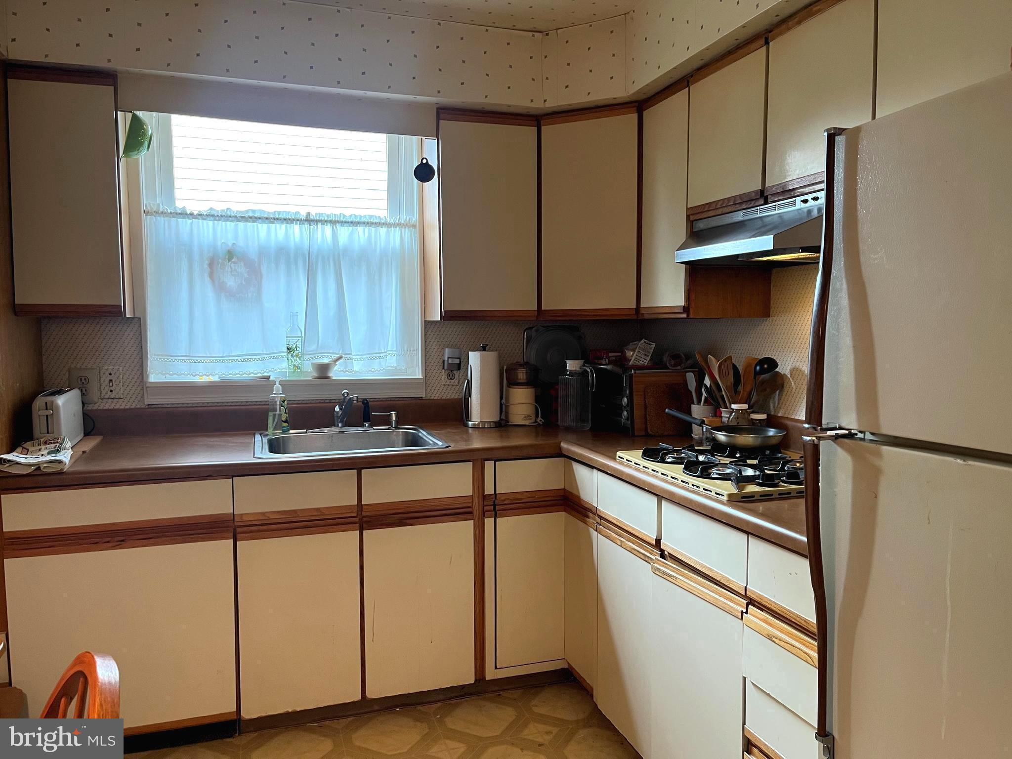 9609 Clark Street Philadelphia, PA 19115 - Photo 13 of 46 a kitchen with stainless steel appliances granite countertop a sink a stove and a refrigerator