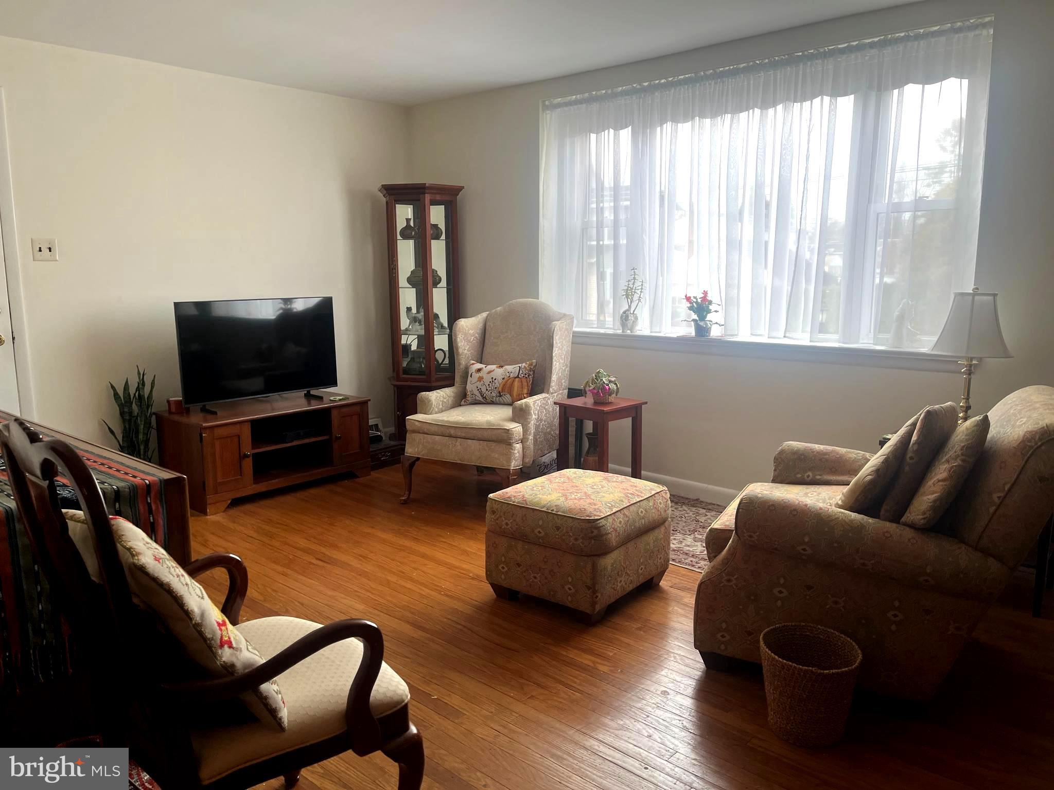 9609 Clark Street Philadelphia, PA 19115 - Photo 7 of 46 a living room with furniture and a flat screen tv
