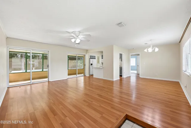 a view of a kitchen with wooden floor and a window
