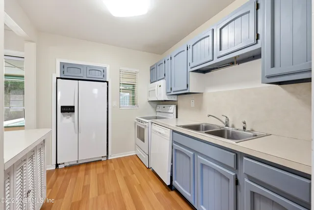 a kitchen with a stove top oven sink and cabinets
