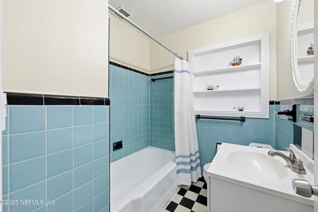 a kitchen with white cabinets and wooden floor