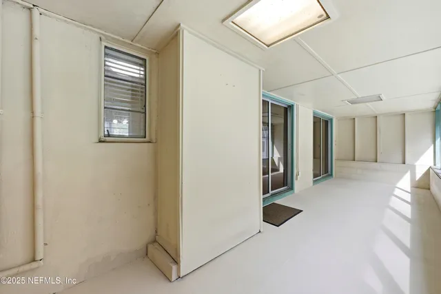 a view of an empty room with a large window