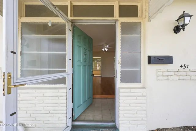 a room with a bed and wooden floor