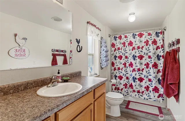 a bathroom with a sink toilet and shower