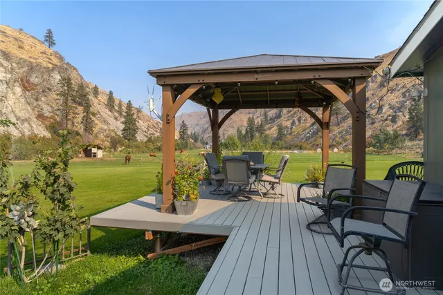a view of patio with table and chairs under an umbrella