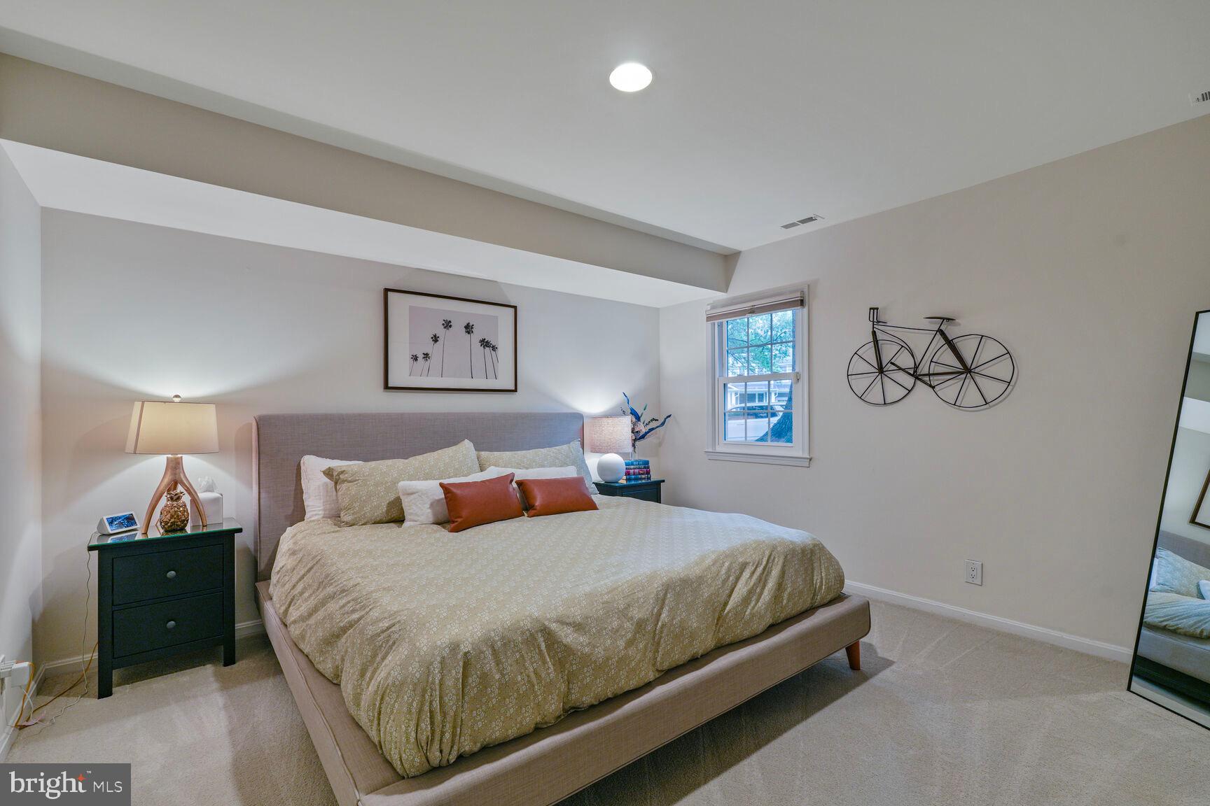 2327 North Glebe Road Arlington, VA 22207 - Photo 19 of 25 a bedroom with a large bed and a lamp on dresser