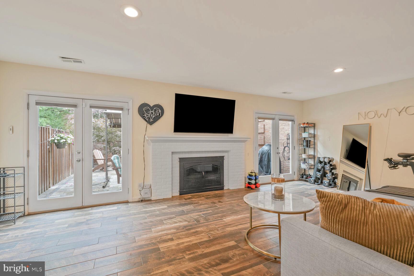 2327 North Glebe Road Arlington, VA 22207 - Photo 21 of 25 a living room with furniture a fireplace and a flat screen tv