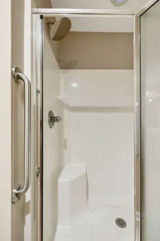 a bathroom with a glass shower door