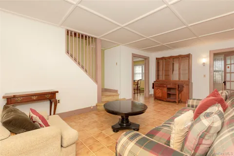 a living room with furniture and a dining table with projector