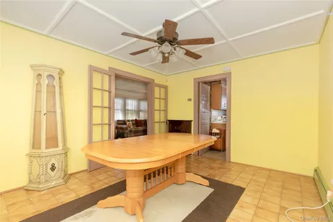 a view of a dining room with a table and chairs