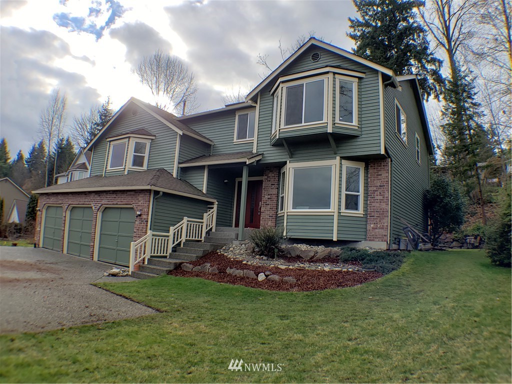 502 224 Place Southeast Bothell, WA 98021 - Photo 1 of 39 a view of a brick house with a large windows and a yard