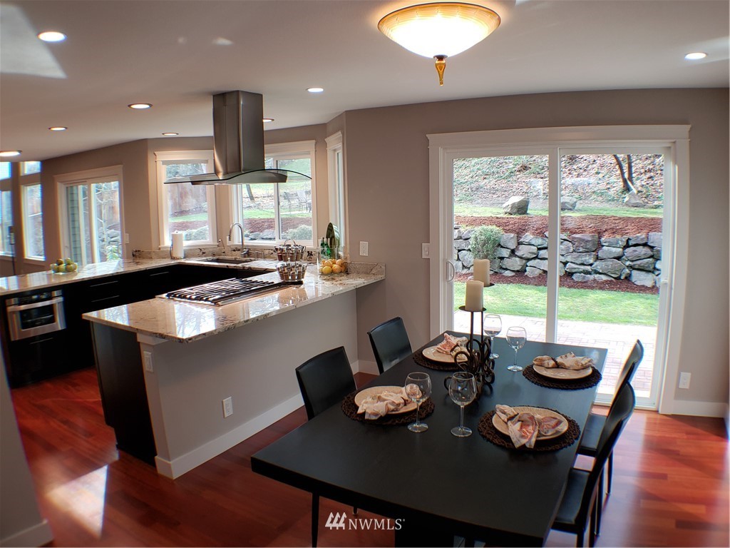 502 224 Place Southeast Bothell, WA 98021 - Photo 11 of 39 a kitchen with a table chairs stove and kitchen island
